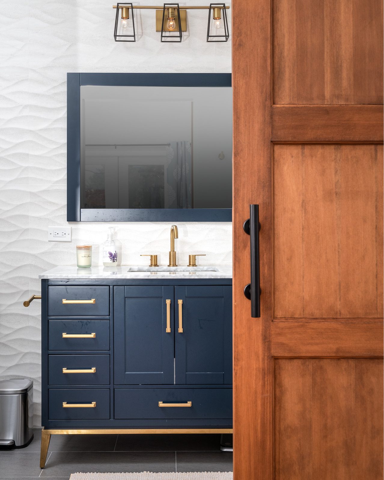 Navy & brass bath, sculpted tile walls