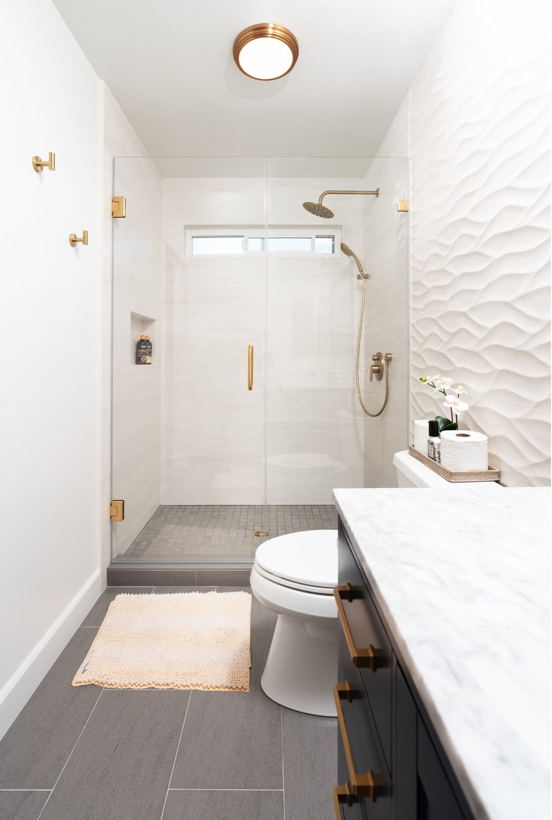 Walk-in shower with brass trim