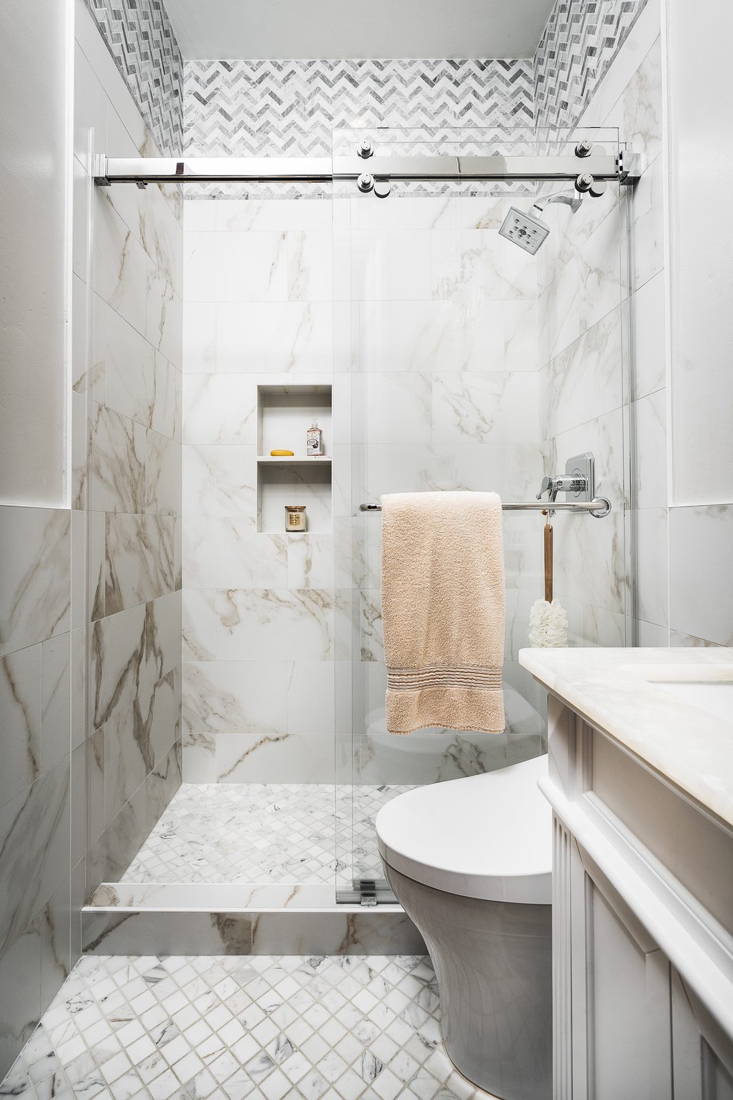 Marble walk-in shower with sliding glass