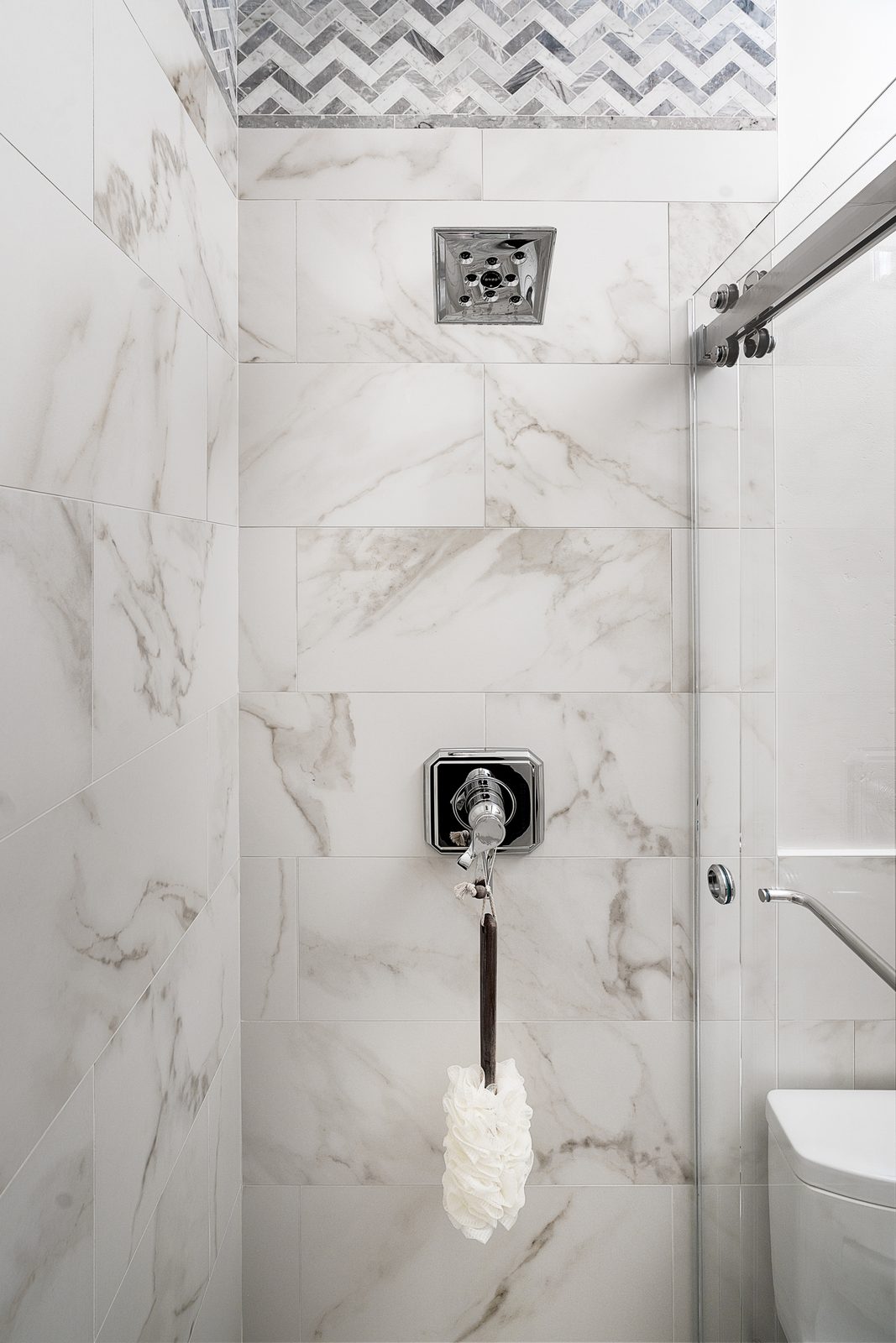 Chevron mosaic over polished field tile